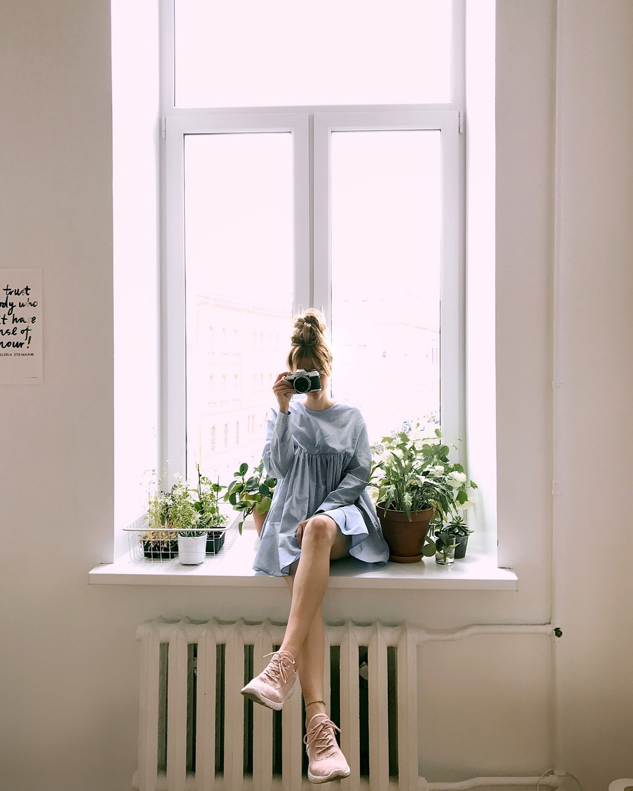 Woman in Grey Long-sleeved Dress Sitting on Window